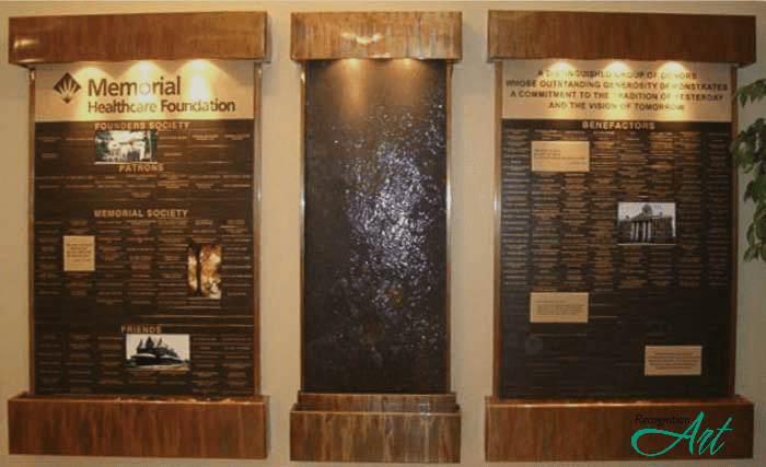 Three piece bronze metal running waterfall donor recognition display with engraved Corian donor names and lighting for Memorial Healthcare Foundation